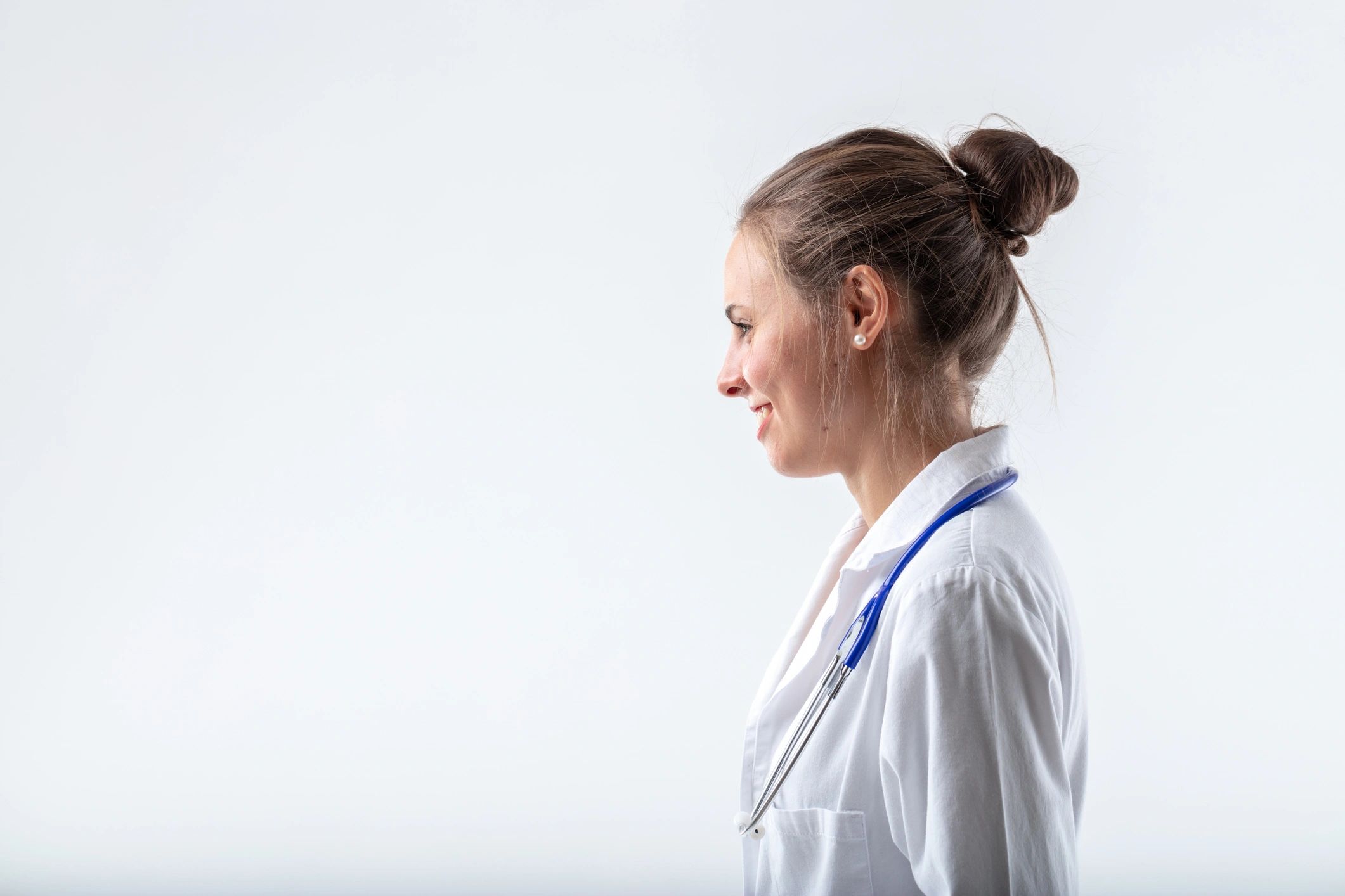 Caregiver holding ID badge, smiling
